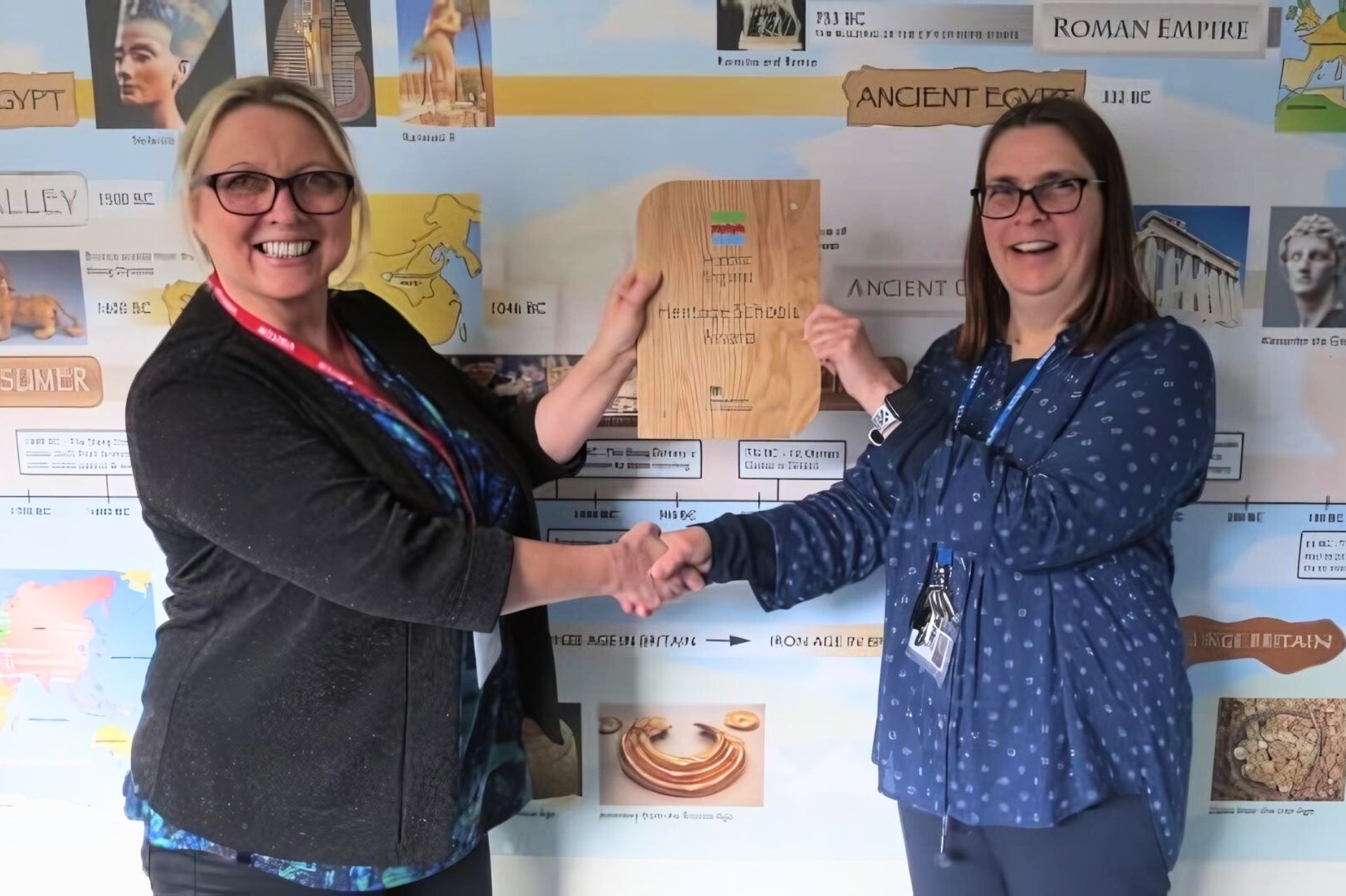 A teacher shaking Haidee Thomas' hand as she is presented with the Heritage Award