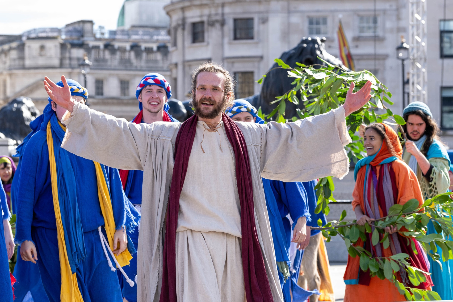 Man playing Jesus with an embracing smile and arms opend wide