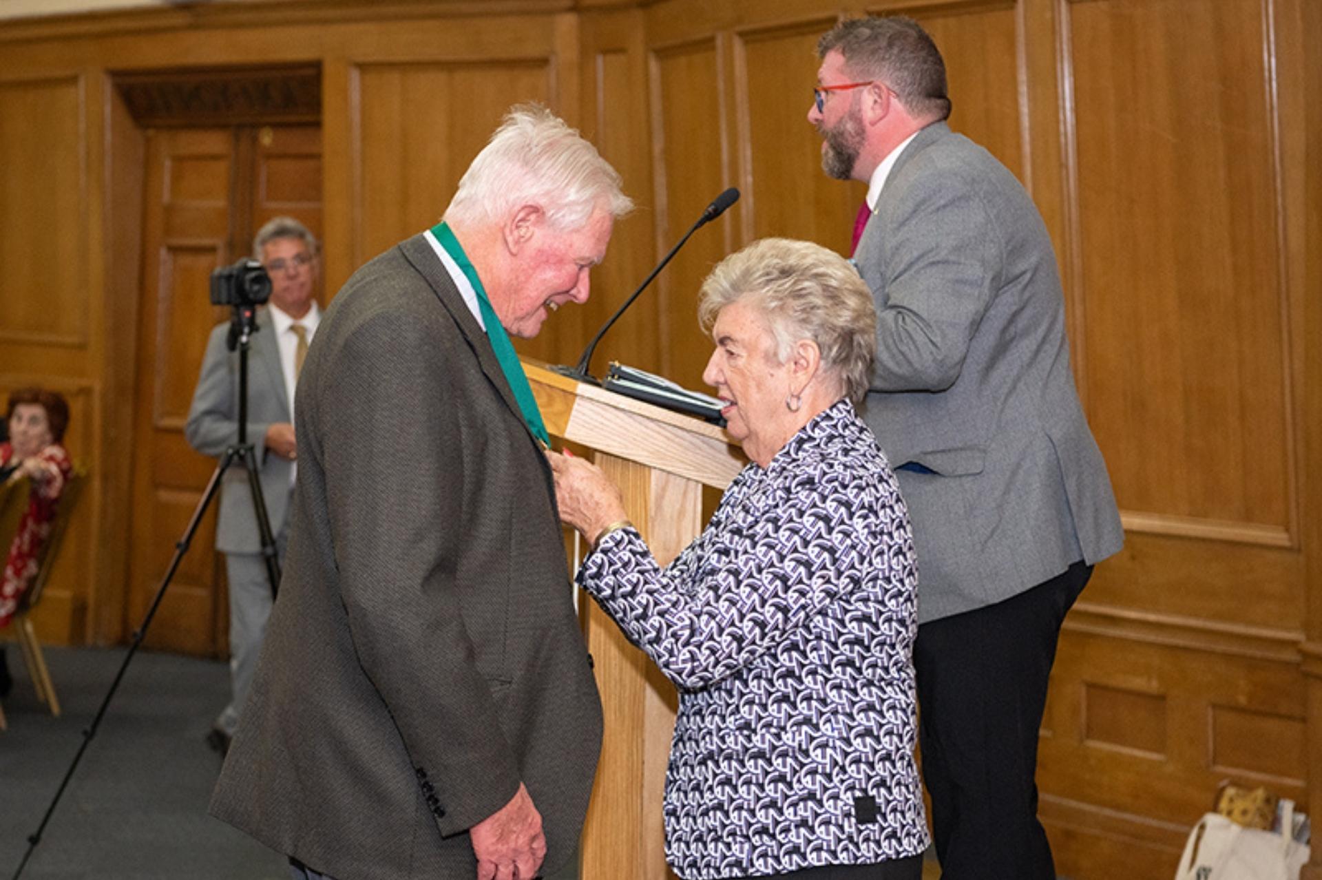 Dr John Verity receiving award from Christine Kilmister