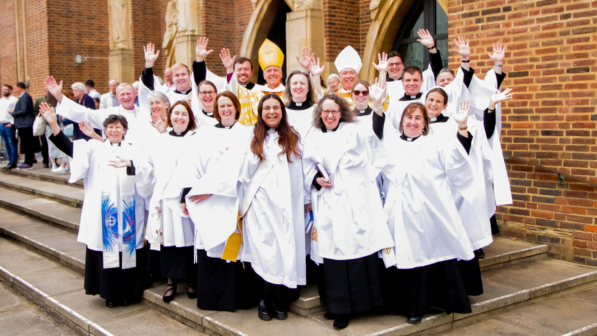 Deacons in full clerical attire celebrate their ordination with Bishop Andrew