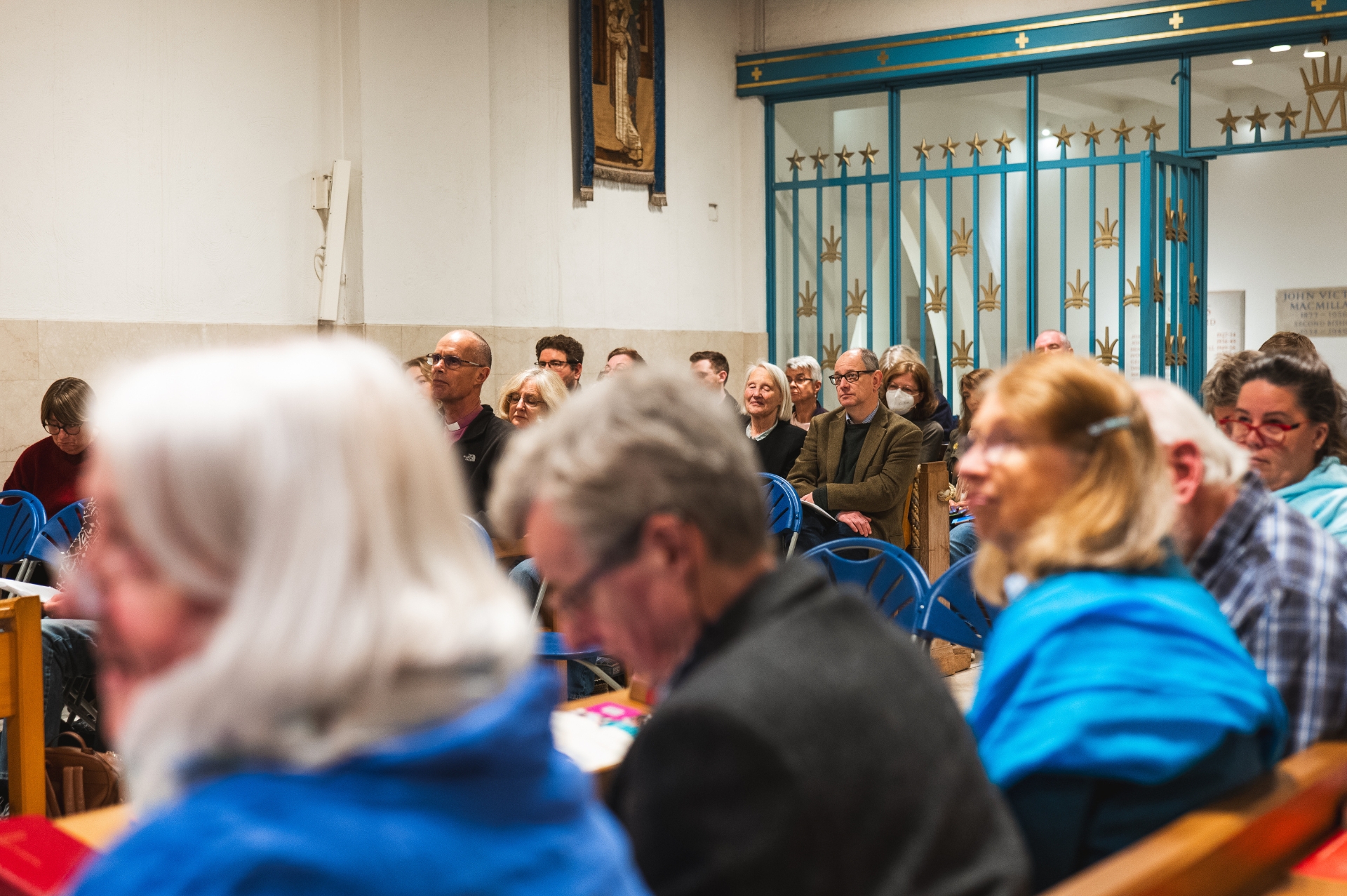 Chapel filled with men and women listening intently to a lecture