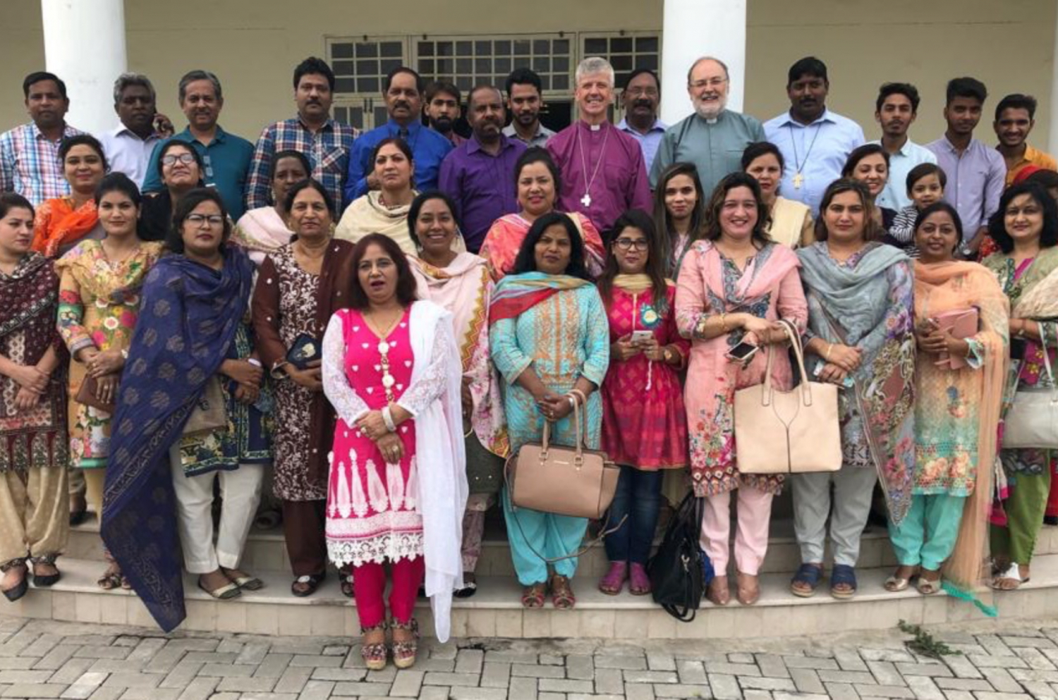 The Bishop of Guildford standing with a Church community in Pakistan