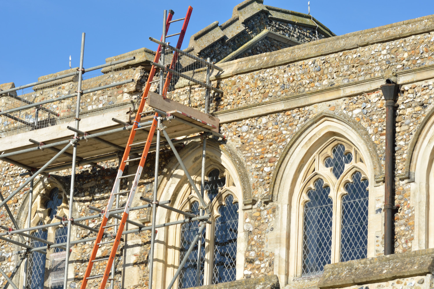 Scaffolding set up beside a stone church