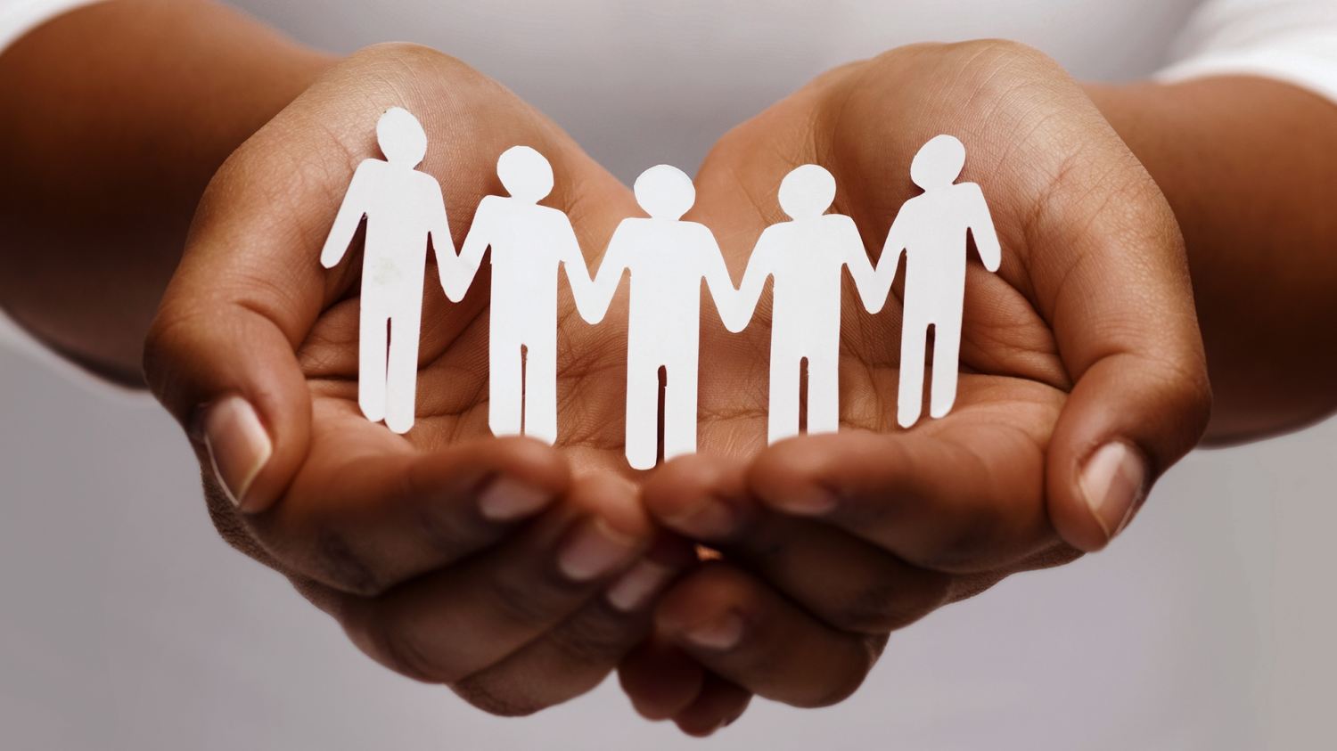 Hands holding a people paper chain