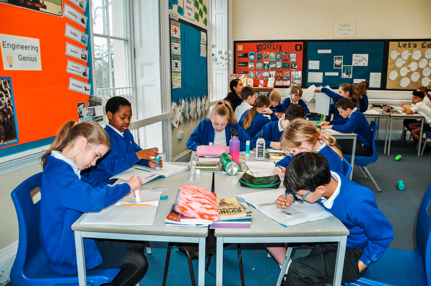 School children at desks doing activities 