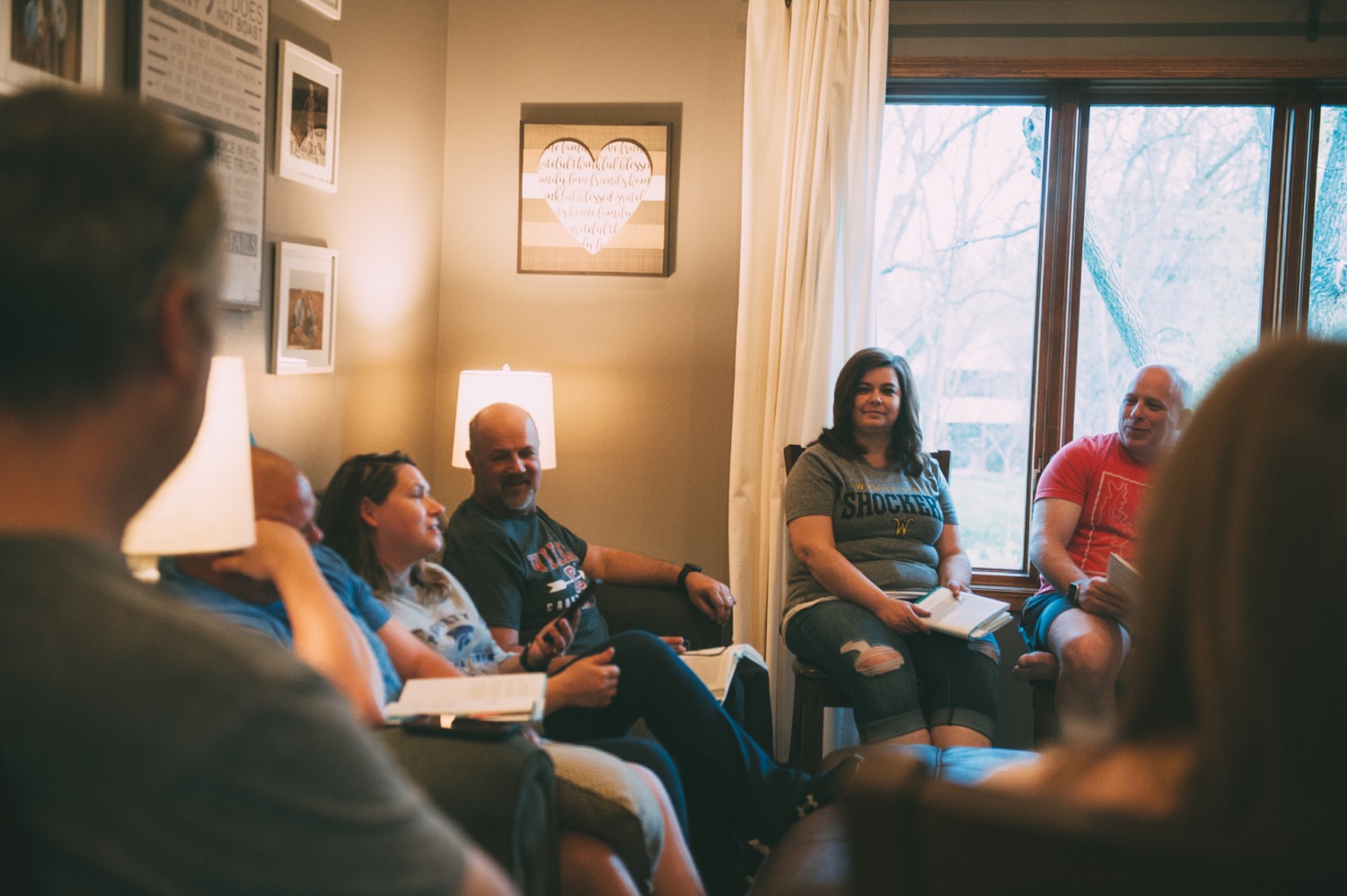 People sat in discussion in a living room