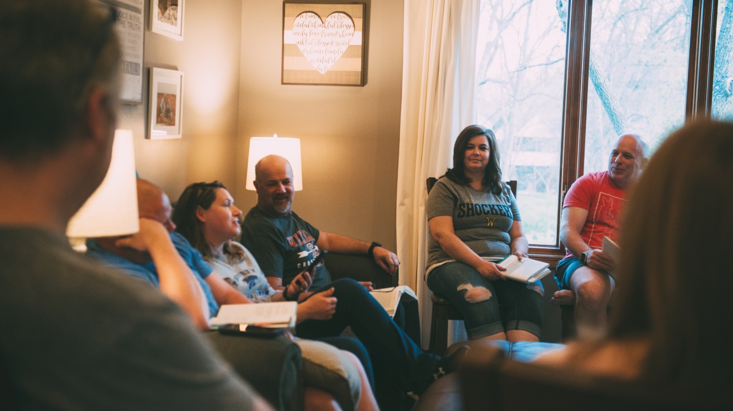 People sat in discussion in a living room