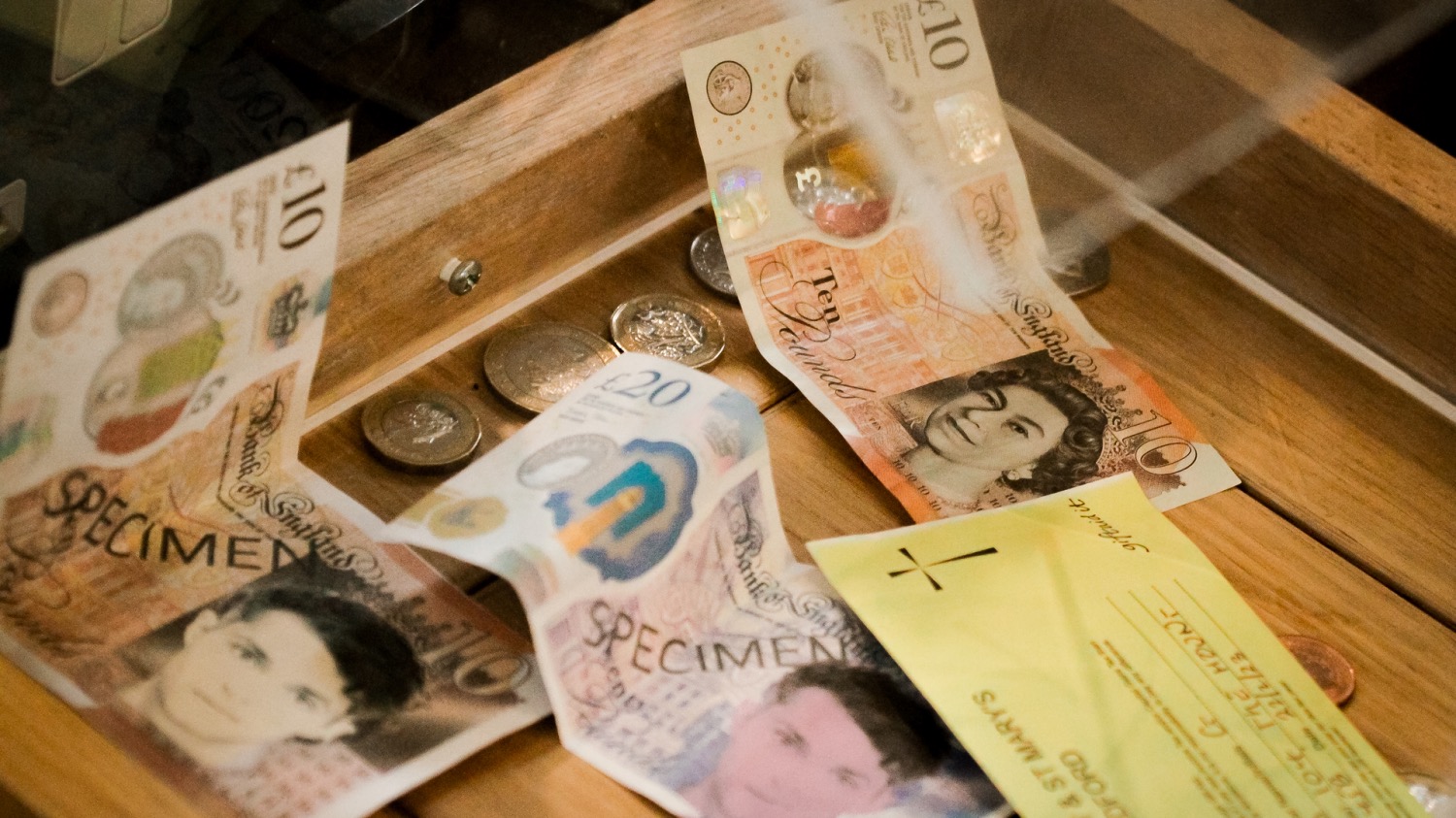 Collection box with pound notes and coins