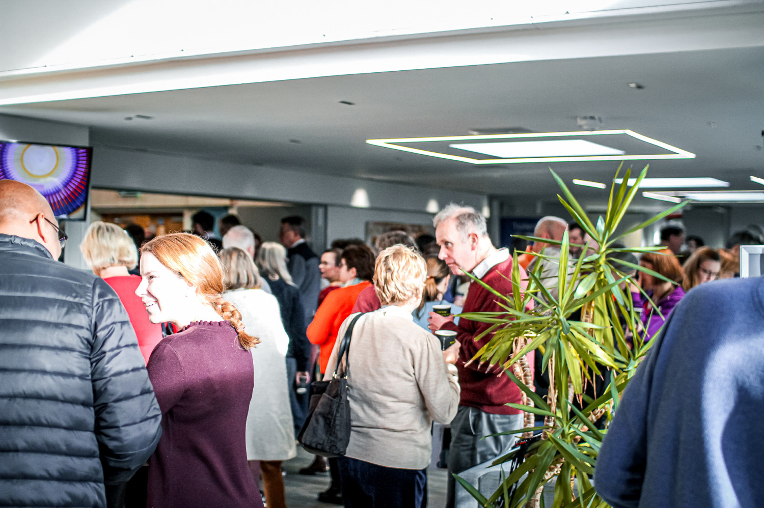 Crowd of people in various conversations