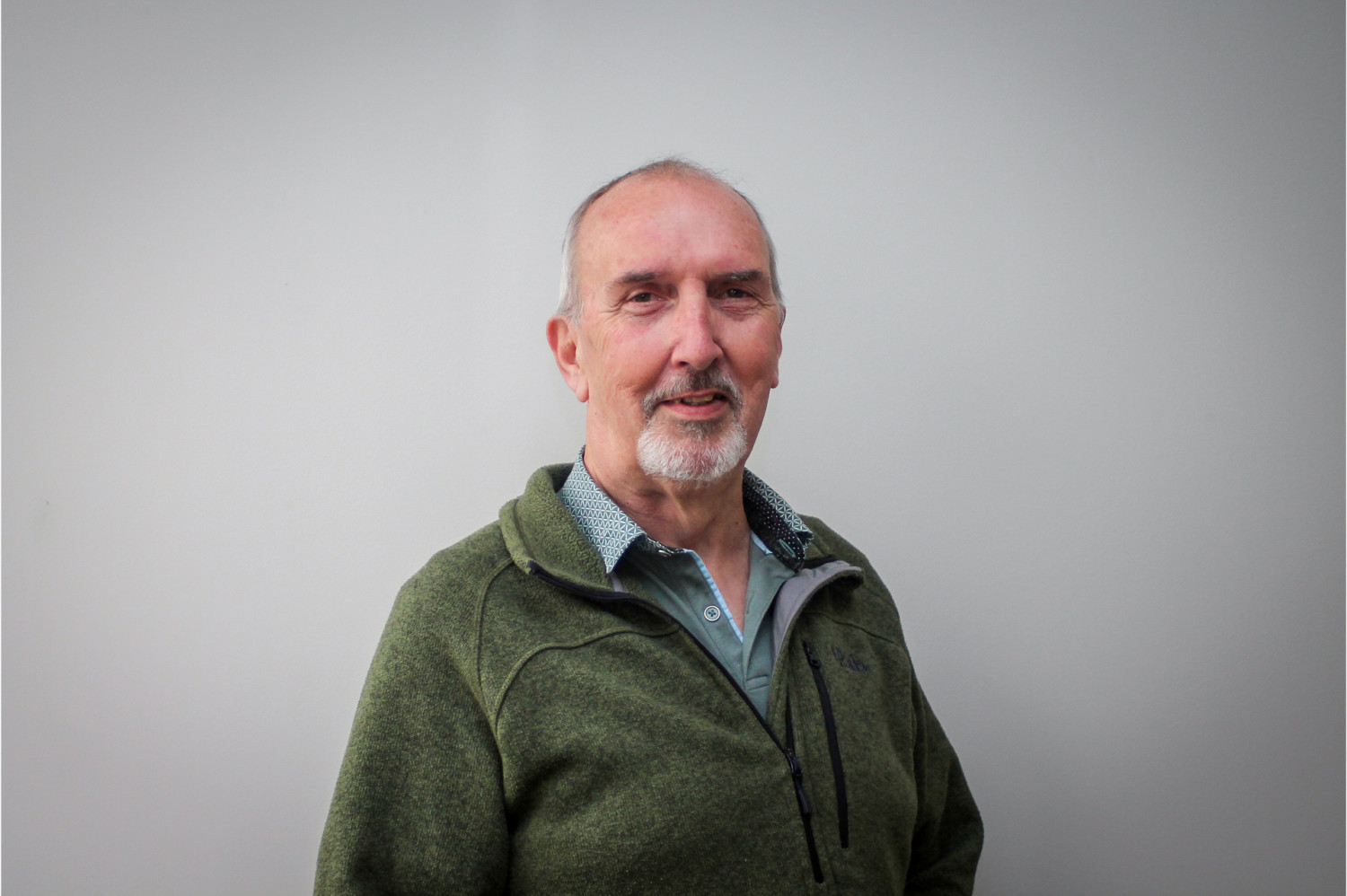 David Phillips smiling wearing a shirt and green fleece