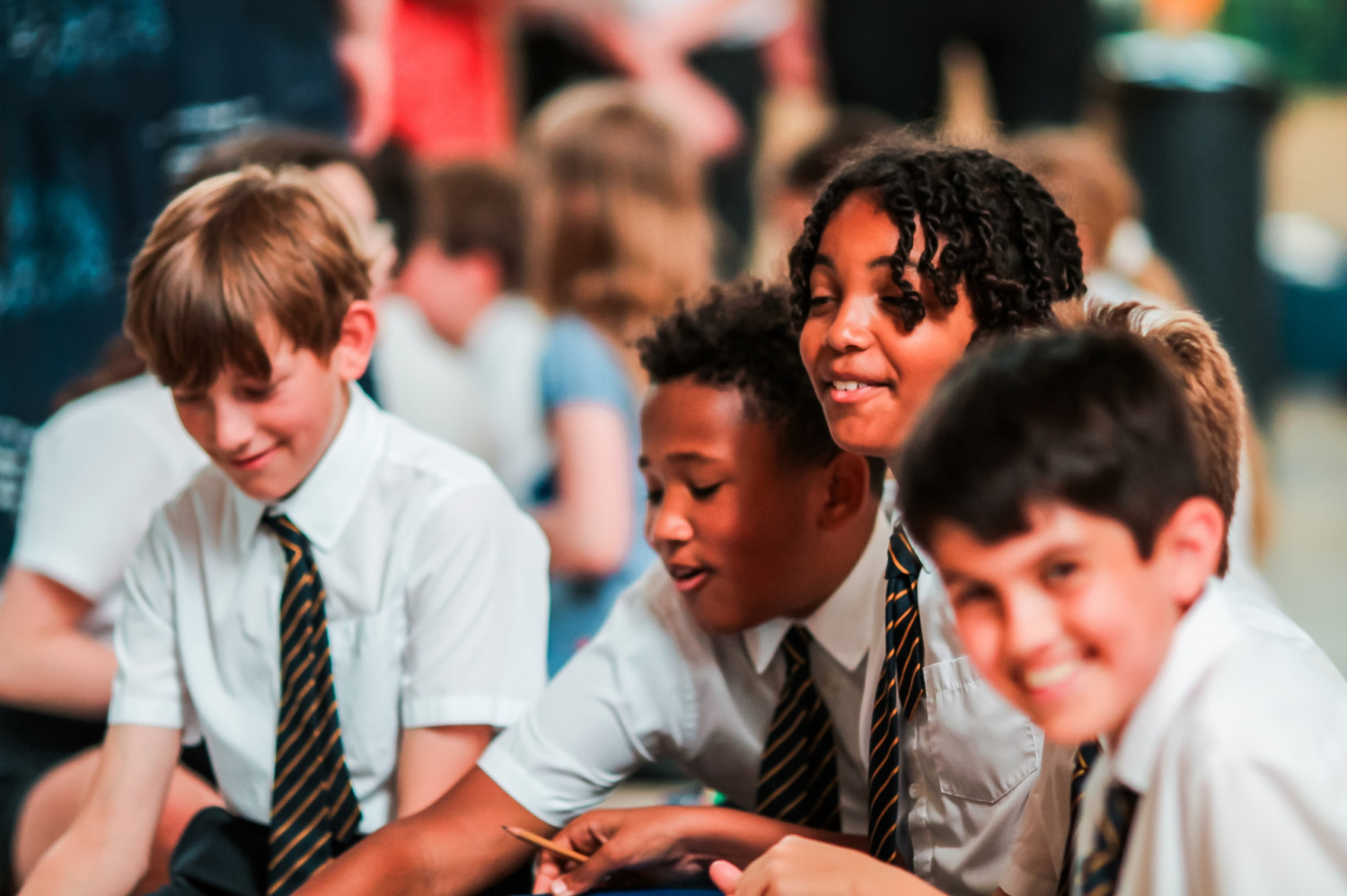 School boys wearing smiling as they engage in an activity